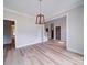 Bright living room featuring a modern chandelier, hardwood floors, and neutral wall color at 240 Mark Ryan Ln, Dallas, NC 28034