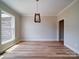 Bright living room featuring a modern chandelier, hardwood floors, and neutral wall color at 240 Mark Ryan Ln, Dallas, NC 28034