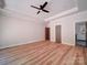 Spacious main bedroom features wood floor, tray ceiling, and ceiling fan with easy access to bathroom at 240 Mark Ryan Ln, Dallas, NC 28034