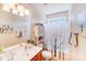 Bright bathroom with a wood vanity, single sink, and decorative shower curtain at 2813 Monterrey Ln, Monroe, NC 28110