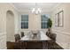 Elegant dining room with hardwood floors, wainscoting, modern chandelier, and natural light at 3064 Virginia Trail Ct, Fort Mill, SC 29715