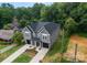 A beautiful new construction townhome with a black roof, gray siding, and a well-manicured yard with fresh landscaping at 3627 Rogers St, Charlotte, NC 28208