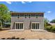 Back exterior of a new grey duplex featuring large sliding glass doors leading to concrete patios at 3627 Rogers St, Charlotte, NC 28208