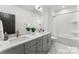 Modern bathroom with a double sink vanity, white subway tiles, and a shower-tub combo at 3627 Rogers St, Charlotte, NC 28208