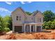 New construction duplex featuring light grey siding, a covered entrance, and two attached garages at 3627 Rogers St, Charlotte, NC 28208