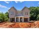 New construction duplex featuring light grey siding, white columns, and attached garages at 3627 Rogers St, Charlotte, NC 28208
