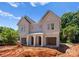 New construction duplex with light grey siding, covered entrance, and attached garage on a sunny day at 3627 Rogers St, Charlotte, NC 28208