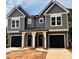 Charming gray two-story townhome features a covered entrance and black garage doors at 3627 Rogers St, Charlotte, NC 28208