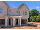 New construction duplex with light grey siding, a covered entryway, and attached garage at 3627 Rogers St, Charlotte, NC 28208
