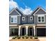 Charming gray two-story townhome features a covered entrance and black garage doors at 3627 Rogers St, Charlotte, NC 28208