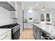 Contemporary kitchen featuring an island, stainless steel appliances, hardwood floors, and ample counter space at 3627 Rogers St, Charlotte, NC 28208