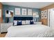 Stylish bedroom boasts a blue velvet headboard, neutral walls, and sophisticated decor at 3757 Fieldhaven Ct, Maiden, NC 28650
