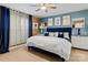 Stylish bedroom boasts a blue velvet headboard, neutral walls, and sophisticated decor at 3757 Fieldhaven Ct, Maiden, NC 28650
