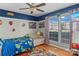 Brightly decorated bedroom with a ceiling fan, large window, and playful decor at 3757 Fieldhaven Ct, Maiden, NC 28650