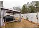 Backyard features a hot tub under a gazebo, surrounded by manicured landscaping, and a white privacy fence at 393 Brannon Meadows Dr, York, SC 29745
