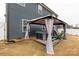 Backyard features a hot tub under a gazebo, surrounded by manicured landscaping and blue siding at 393 Brannon Meadows Dr, York, SC 29745