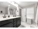 Bright bathroom features double vanity, modern fixtures, a large mirror and a glass enclosed walk-in shower at 393 Brannon Meadows Dr, York, SC 29745