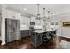 Modern kitchen with white cabinets, stainless steel appliances, a center island and hardwood floors at 393 Brannon Meadows Dr, York, SC 29745