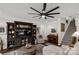 Living room with a ceiling fan, staircase, and a large entertainment center at 393 Brannon Meadows Dr, York, SC 29745