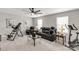 This living room features an exercise area, a leather sofa, and carpet flooring at 393 Brannon Meadows Dr, York, SC 29745