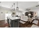Open concept living space featuring hardwood floors, a modern kitchen island, and a cozy living room at 393 Brannon Meadows Dr, York, SC 29745