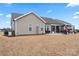 Rear view of a home with an expansive lawn, covered patio and well-maintained landscaping at 4000 Spring Cove Way, Belmont, NC 28012