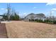 Expansive backyard with immature landscaping and a home with a three-car garage, perfect for outdoor enjoyment at 4000 Spring Cove Way, Belmont, NC 28012