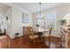 Bright dining room with hardwood floors and large windows, creating a warm and inviting atmosphere at 4000 Spring Cove Way, Belmont, NC 28012