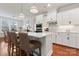 Modern kitchen with white cabinets, quartz countertops, stainless steel appliances, and stylish pendant lighting at 4000 Spring Cove Way, Belmont, NC 28012