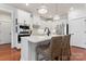 Modern kitchen with white cabinets, quartz countertops, stainless steel appliances, and stylish pendant lighting at 4000 Spring Cove Way, Belmont, NC 28012