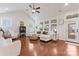 Cozy living room boasts a vaulted ceiling, large windows, hardwood floors, and ample natural light at 4000 Spring Cove Way, Belmont, NC 28012