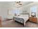 Peaceful primary bedroom with tray ceiling, neutral decor, and comfortable furnishings at 4000 Spring Cove Way, Belmont, NC 28012