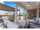 Screened-in patio with comfortable seating, fan, grill, TV, and outdoor dining area for relaxing and entertaining at 4000 Spring Cove Way, Belmont, NC 28012