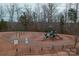 Aerial view of the community playground, surrounded by trees and offering a safe place for to play at 4000 Spring Cove Way, Belmont, NC 28012