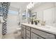 Elegant bathroom featuring dual vanities, a bathtub with a shower, and modern lighting at 4004 Caymen Bay Ct, Tega Cay, SC 29708