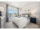 Bright bedroom featuring large windows, a plush bed, and stylish decor at 4004 Caymen Bay Ct, Tega Cay, SC 29708
