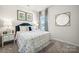 Bright bedroom featuring a window, a comfortable bed, and stylish wall decor at 4004 Caymen Bay Ct, Tega Cay, SC 29708
