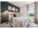 Stylish bedroom featuring a large window, bold decor, and a cozy bed at 4004 Caymen Bay Ct, Tega Cay, SC 29708