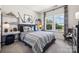 Comfortable bedroom with decor, including a large window and stylish furnishings at 4004 Caymen Bay Ct, Tega Cay, SC 29708