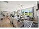Bright, open living room with large windows, hardwood floors, modern furniture, and a view to the kitchen at 4004 Caymen Bay Ct, Tega Cay, SC 29708