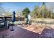 Brick patio with furniture and play structure in backyard at 435 Caldwell Se Dr, Concord, NC 28025