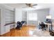 Bright bedroom with built-in shelving, desk space, and a parquet wood floor at 435 Caldwell Se Dr, Concord, NC 28025