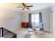 Bedroom with a chair, crib, and neutral colors, and a ceiling fan at 435 Caldwell Se Dr, Concord, NC 28025