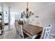 Open-concept dining room adjacent to the living area, featuring a modern chandelier and ample seating at 435 Caldwell Se Dr, Concord, NC 28025