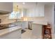 Well-lit kitchen featuring white cabinets, subway tile backsplash, and stainless steel appliances at 435 Caldwell Se Dr, Concord, NC 28025