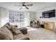 Bright living room with a fireplace and a large window, offering a cozy seating area at 435 Caldwell Se Dr, Concord, NC 28025