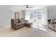 Cozy living room with large windows and a comfortable sofa with ottoman, filled with natural light at 435 Caldwell Se Dr, Concord, NC 28025