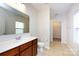 A bathroom featuring a single vanity, mirror, tile flooring and view to the walk-in closet at 5216 Crystal Lakes Dr, Rock Hill, SC 29732