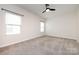 Comfortable bedroom featuring plush neutral carpet, a ceiling fan, and two windows for natural light at 5216 Crystal Lakes Dr, Rock Hill, SC 29732