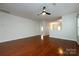 Spacious living area showcasing hardwood floors and a ceiling fan, leading to the kitchen and entryway at 5216 Crystal Lakes Dr, Rock Hill, SC 29732